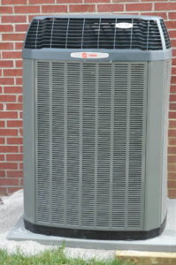 A Trane XL20 air conditioning unit installed outside a brick home by Extreme Heating and Cooling II - Indiana in Westfield, IN.