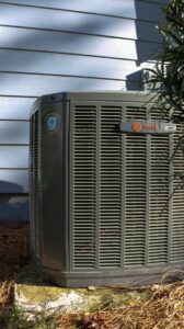 An outdoor Trane XR air conditioner unit with the Green Dot Heating & Air logo, ready for service in Wilmington, NC.