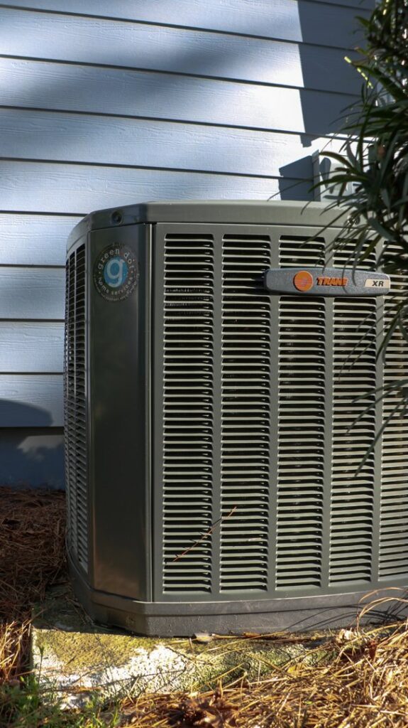 An outdoor Trane XR air conditioner unit with the Green Dot Heating & Air logo, ready for service in Wilmington, NC.