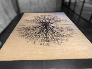 A large area rug featuring a distinctive tree design, offered by FabriCare in Rockville, MD.