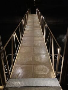 Outdoor seating area with trees beautifully illuminated by uplighting installed by Get Lit KC & LOZ in Kansas City, KS.