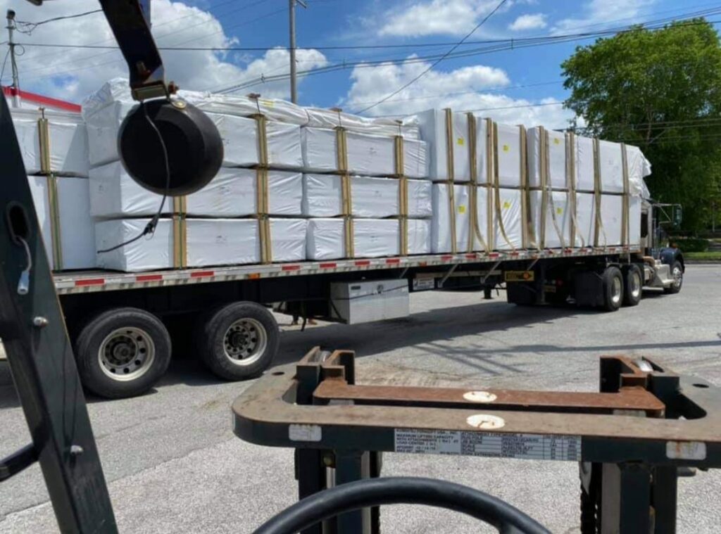 A truck loaded with wrapped fence panels, ready for delivery by Future Solutions Fence Supply in York, PA