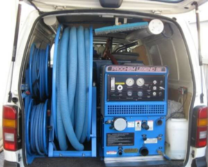 Truck-mounted carpet cleaning equipment and hoses in a service van for Carpet Clean Oahu in Honolulu, HI.