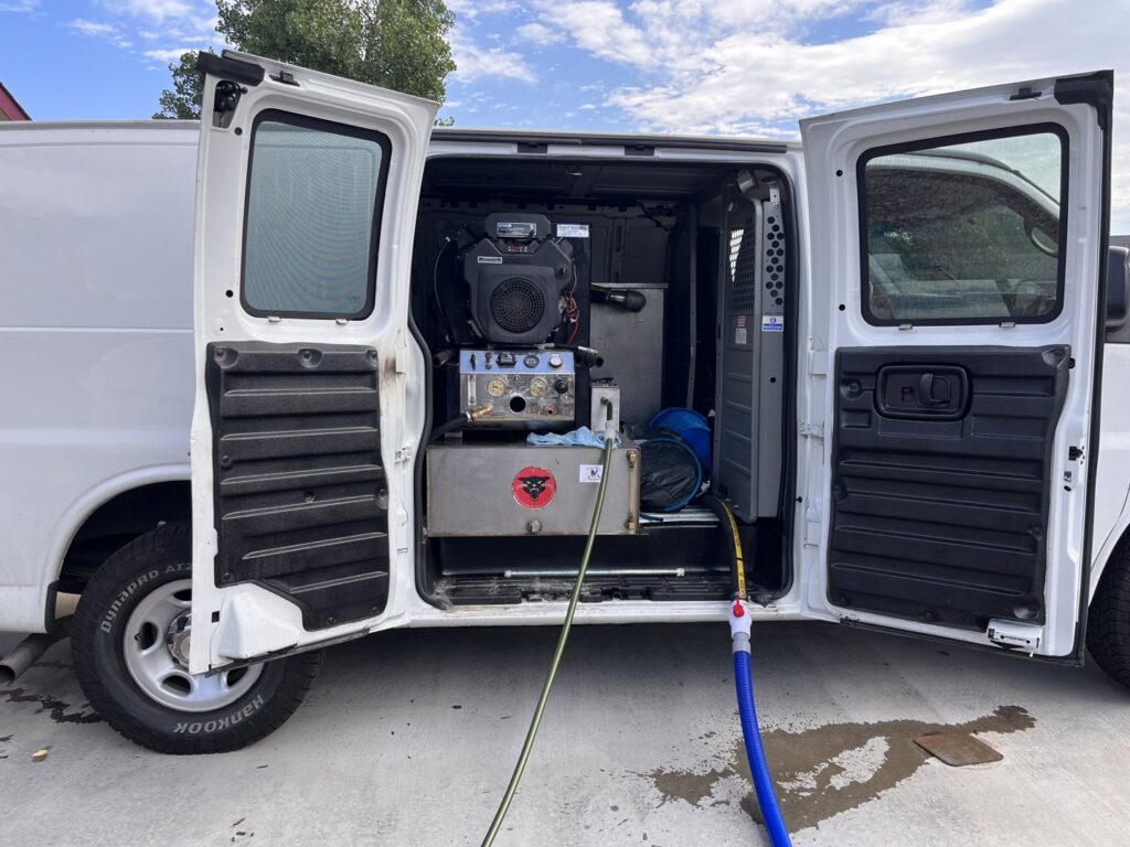 Professional truck-mounted carpet cleaning equipment set up in a van by Tailor Maid Carpet Cleaning in Colorado Springs, CO.