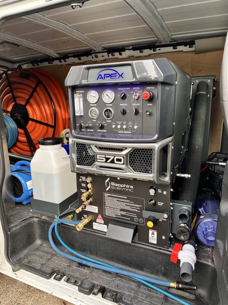 A powerful truck-mounted carpet cleaning machine inside a service van for Pacific Steam Carpet Cleaning in Gresham, OR.