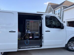 A truck-mounted carpet cleaning unit installed inside a service van for Alex's Carpet Cleaning in Omaha, NE.