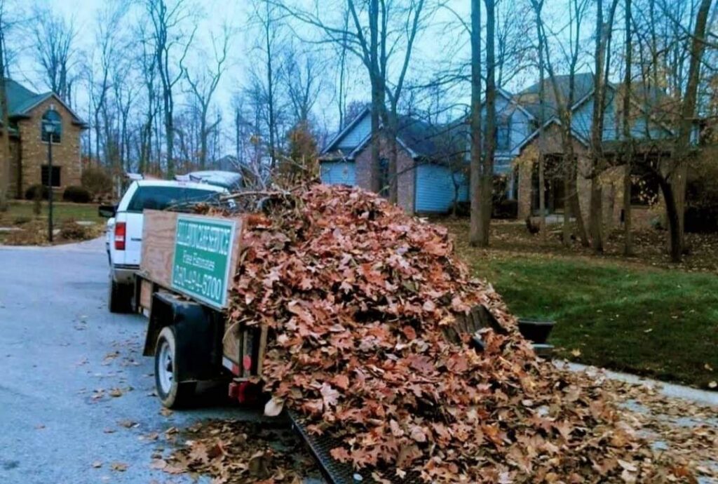 A truck with a trailer full of leaves after a fall cleanup service by ALL Lawn Care Service in Saint Louis, MO