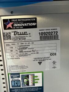 A close-up of a True Refrigeration unit's specification label, indicating service by Setpoint Refrigeration LLC in Liberty Hill, TX