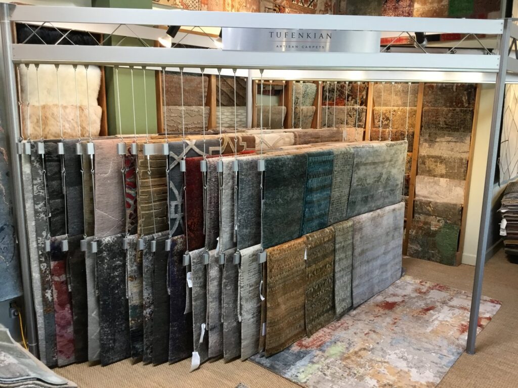 A display of Tufenkian Artisan Carpets hanging in the showroom of David Alan Rugs in Austin, TX.