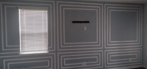 An installed TV mount bracket and electrical outlet on a decorative wall by Miller Electric in Summerville, SC.