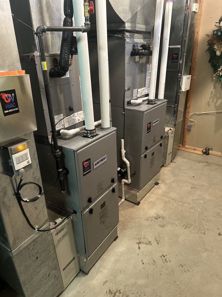 Two Airquest furnaces or air handlers with connected ductwork, installed by Controlled Weather HVAC in Shelby Township, MI.