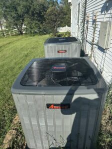 Two Amana outdoor HVAC condenser units installed at a residence by Grand Slam Heating & Air in Baton Rouge, LA.