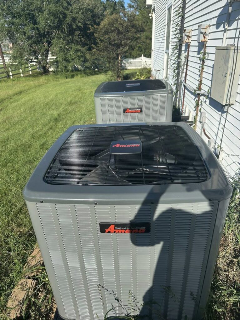 Two Amana outdoor HVAC condenser units installed at a residence by Grand Slam Heating & Air in Baton Rouge, LA.
