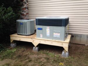Two American Standard outdoor HVAC units installed on a wooden platform by Eastern Air Flow of Kentucky in Richmond, KY.