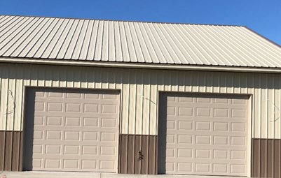 Two beige commercial garage doors installed on an industrial building by SCI Door in Yakima, WA