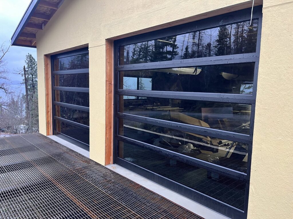 Two stunning black full-view glass garage doors installed by Remarkable Door Company in Spokane, WA.