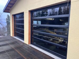 Two stunning black full-view glass garage doors installed by Remarkable Door Company in Spokane, WA.