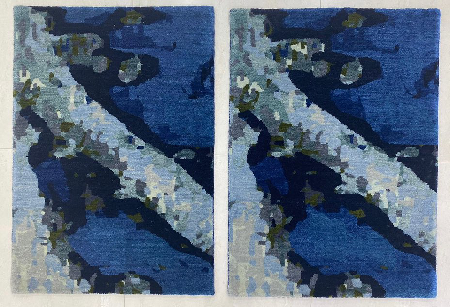 Two blue abstract rugs with intricate patterns displayed by Legacy Looms in Minneapolis, MN.