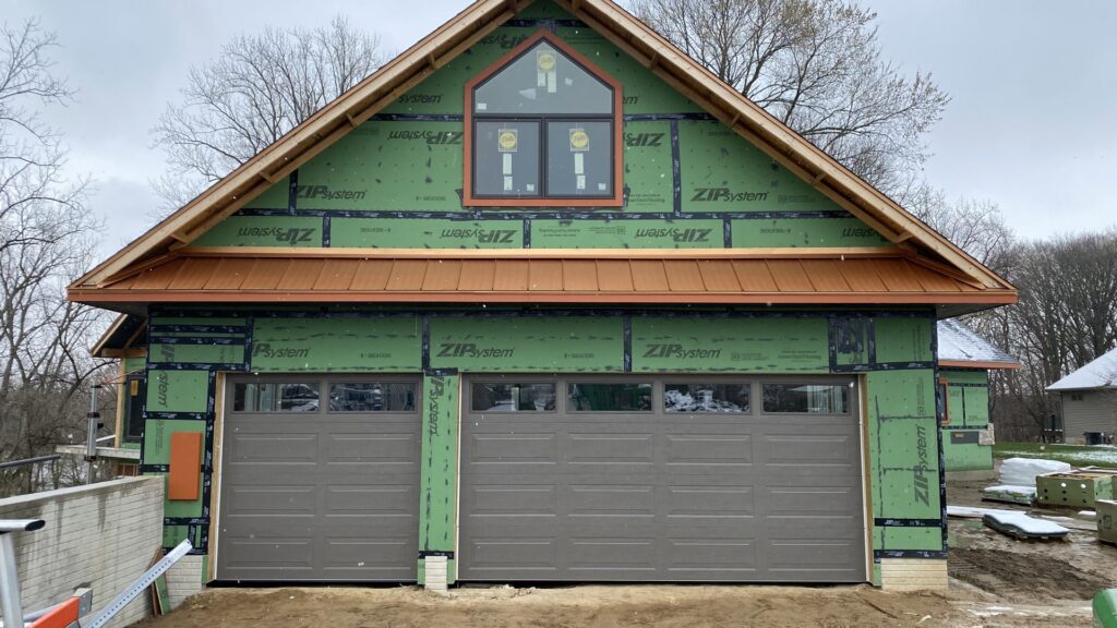 Two brown garage doors installed on a new construction home by Superior Overhead Door, LLC in Granger, IN