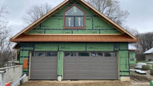 Two brown garage doors installed on a new construction home by Superior Overhead Door, LLC in Granger, IN