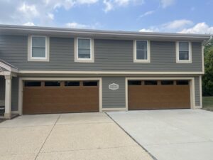 Two newly installed brown residential garage doors with top windows by McDonald Overhead Door Inc. in Kenosha, WI.
