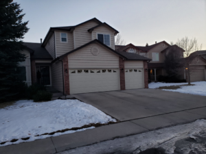 A residential house featuring two garage doors installed by 170 Springs LLC Garage Doors in Aurora, CO