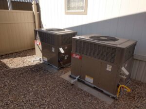 Two Coleman outdoor HVAC condenser units installed side-by-side by Raytech Refrigeration, Heating & Cooling in Alamogordo, NM.