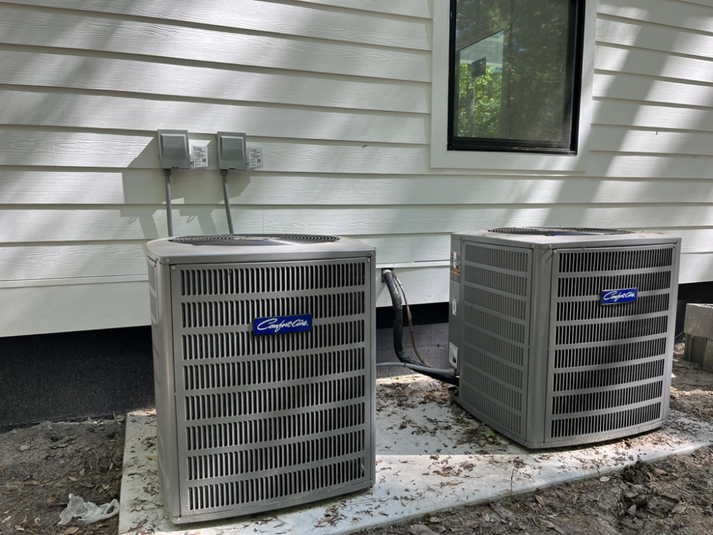 Two Comfort-Aire outdoor AC units professionally installed next to a residential building by West Mechanical in Summerville, SC.