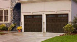 A modern house featuring two dark brown panel garage doors with windows from Frankfort Overhead door Sales & Service in Frankfort, KY