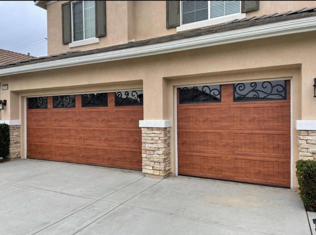 Two decorative brown garage doors with wrought iron accents on a residential home by 101 Garage Doors in Phoenix, AZ.