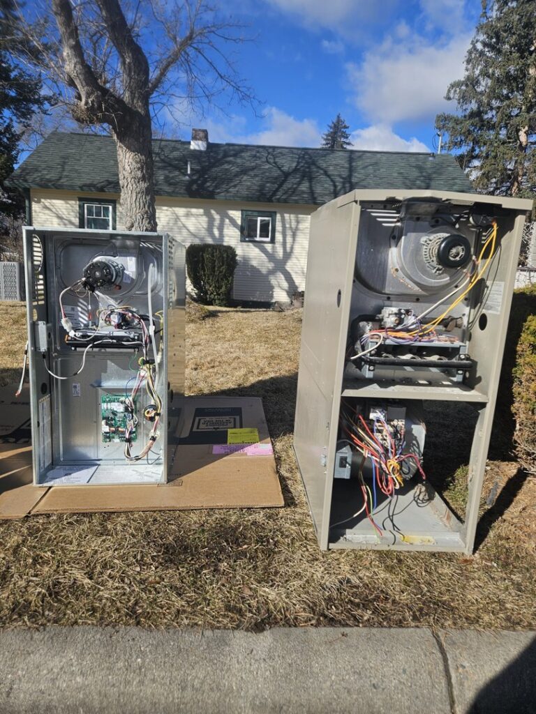 Two furnace units, one new and one old, displayed outdoors by 406 Heating & Cooling LLC in Missoula, MT.