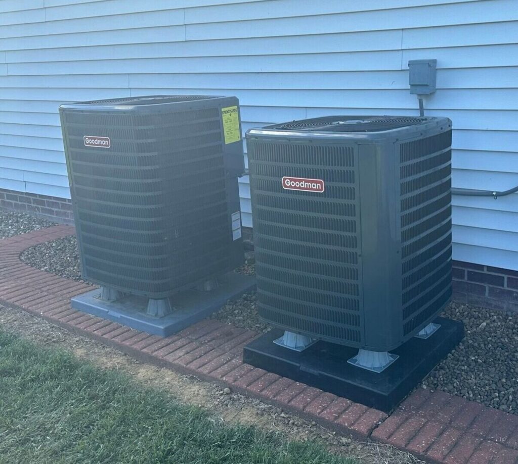 Two outdoor Goodman AC condenser units installed side-by-side by Hodges Heating & Cooling in Owensboro, KY.