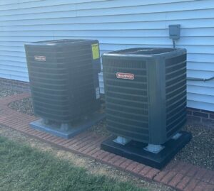 Two outdoor Goodman AC condenser units installed side-by-side by Hodges Heating & Cooling in Owensboro, KY.