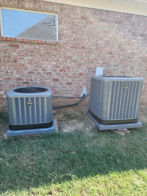 Two Goodman outdoor air conditioning condenser units installed by Smith Heat an Air, LLC in Southaven, MS.