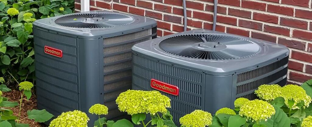 Two Goodman outdoor air conditioning units installed side-by-side by 9-1-1 Heating & Air, LLC for residential cooling in Milwaukee, WI.