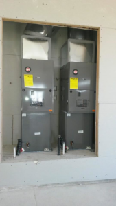 Two new HVAC furnace and air handler units being installed during construction by Proficient Heating & Air Conditioning llc in Livonia, MI.