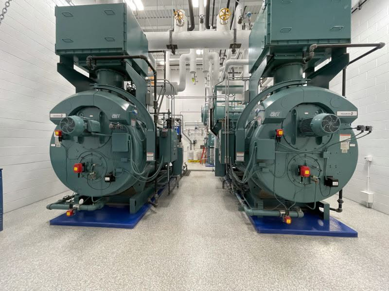 Two large industrial boilers installed side-by-side, showcasing expert work by Dean Boiler, Inc in Grand Rapids, MI.