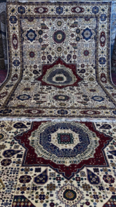 Two intricately patterned carpets showcased on display by Mawr Store, a carpet contractor in Chaman-e-Hozori, Kabul, AF