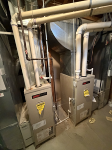 Two Lennox furnaces or air handlers with connected ductwork, installed by Controlled Weather HVAC in Shelby Township, MI.