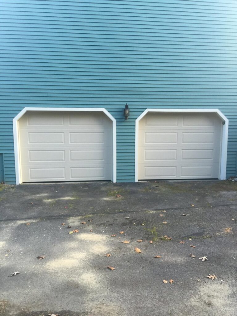 Two light beige panel garage doors installed by Snowbird Garage Doors Company in Worcester, MA.
