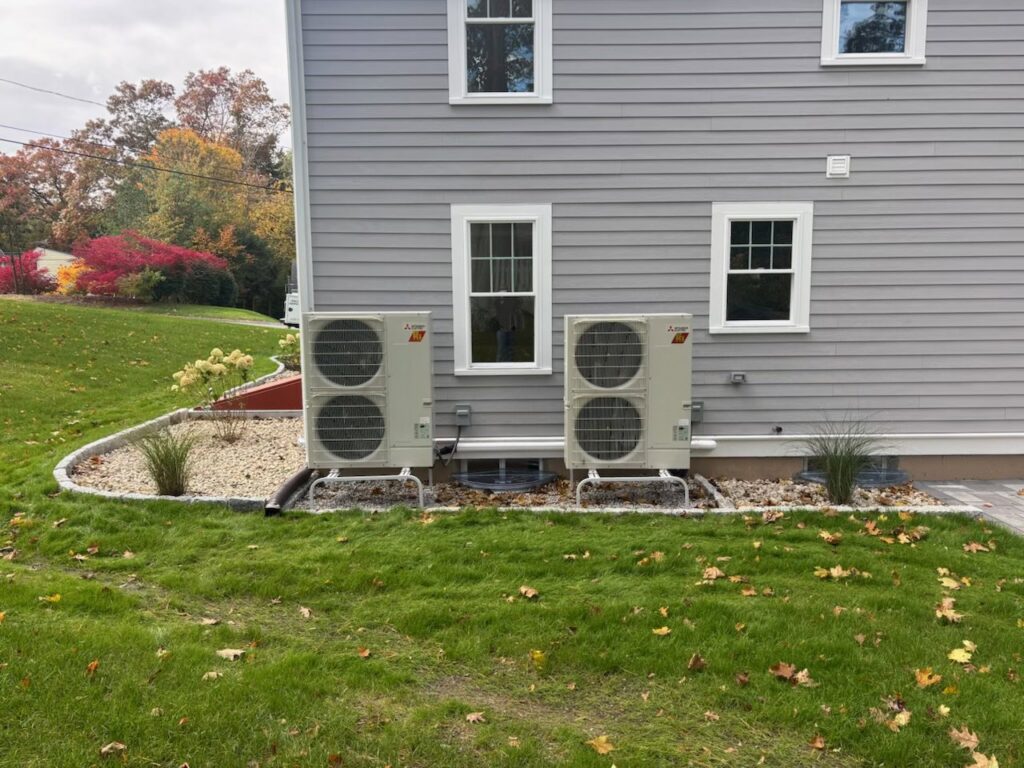 Two Mitsubishi Electric outdoor mini-split HVAC units installed by A&A Mechanical HVAC in Raynham, MA.