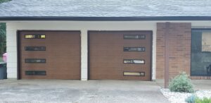 Two modern brown garage doors with horizontal panels and multiple windows, installed by Coast To Coast Garage Door LLC in Vancouver, WA.