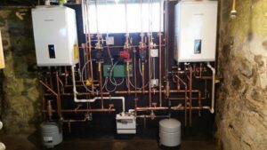 Installation of two Navien tankless water heaters with copper piping by Nicholas Savvas Plumbing & Heating in Derry, NH.