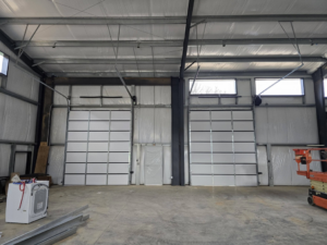 Two new sectional garage doors installed in a commercial building by Coles Garage Door Service, LLC in West Columbia, SC.
