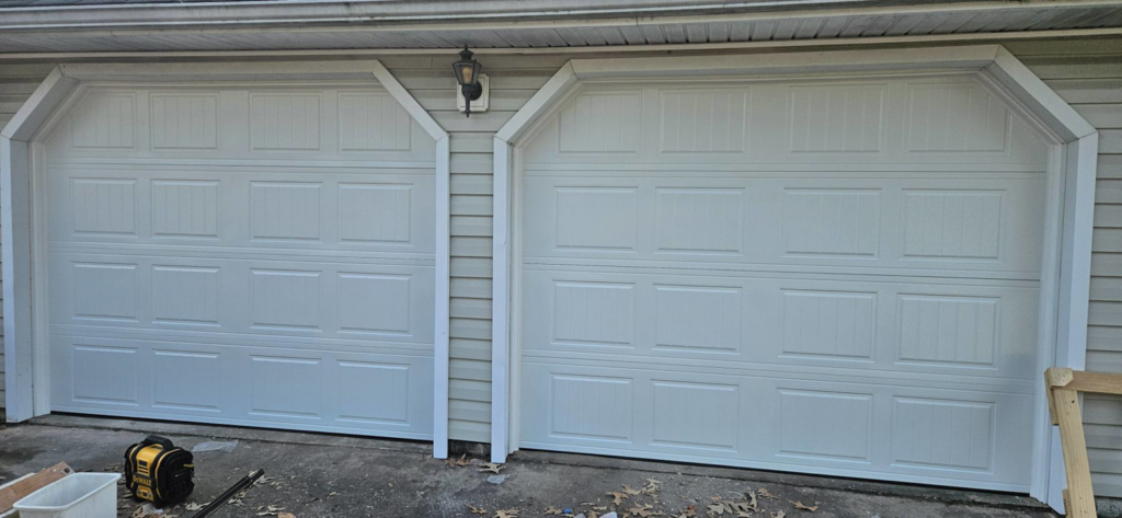 Two newly installed white panel garage doors completed by Skreno Services in Summerville, SC.