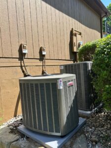 Two outdoor air conditioning condenser units installed by Davenport Service Company in Olathe, KS