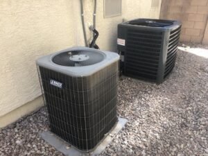 Two outdoor AC condenser units, including a Lennox unit, installed or serviced by Mechanical Express in Henderson, NV.