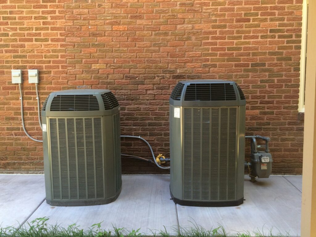 Two outdoor air conditioning condenser units installed by Vision Air Services in Tulsa, OK.