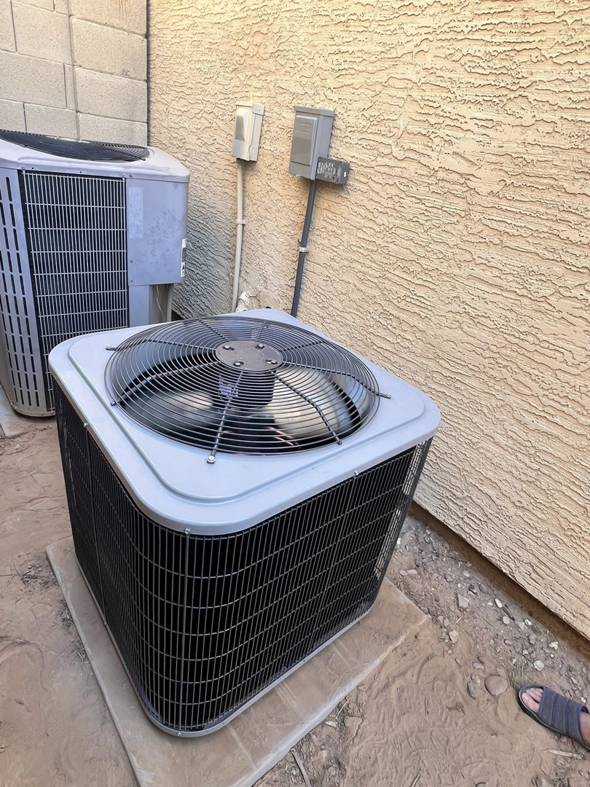 Two outdoor AC condenser units installed by Weather Masters, Inc. in Mesa, AZ.