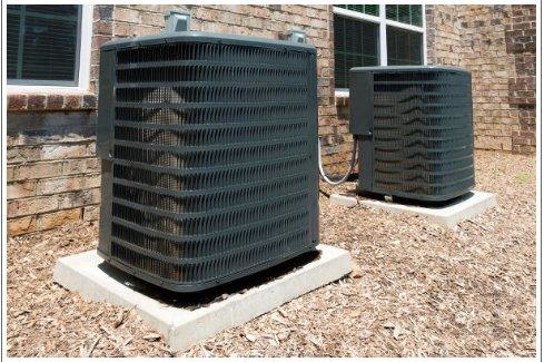 Two outdoor air conditioning units installed by All Comfort Air Heating and Air Conditioning in Raleigh, NC.